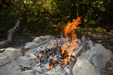 Bonfire, coal and stones in the forest.
