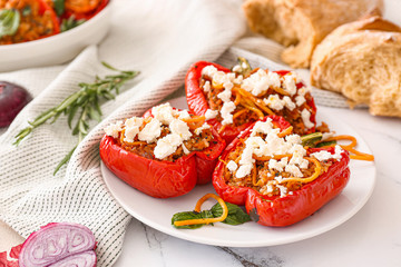 Plate with tasty stuffed pepper on table