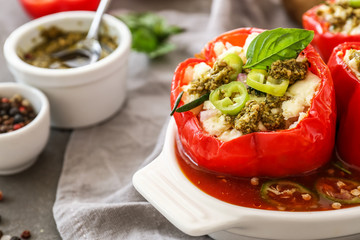 Dish with tasty stuffed pepper on table, closeup