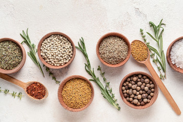 Different dry herbs and spices on white background