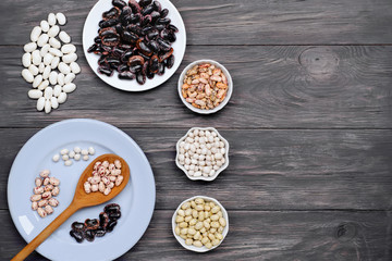  Beans, legumes on wooden background.