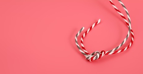 Fototapeta premium Christmas composition with ropes isolated on a pink background