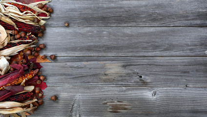 Left border of seasonal Autumn decorations on aged wood for the Thanksgiving holiday background setting