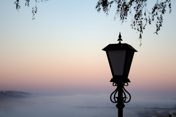  Lantern on a background of fog at sunrise