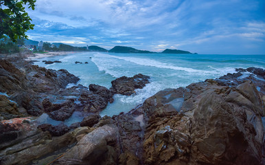 Fototapeta na wymiar Rocky coast of the tropical Patong beach, Phuket Thailand
