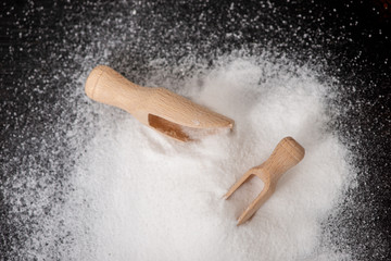 Top view of two scoops with baking soda on wooden table
