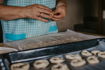 Fototapeta na wymiar hands cooking making donuts or traditional sweets