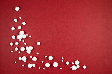 White snow balls over the red background