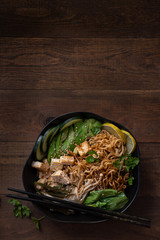 Vegan Ramen Bowl on Wooden Table. Copy space.