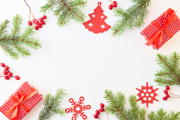 Flat lay frame with spruce branches, christmas decorations and gift box on a white background