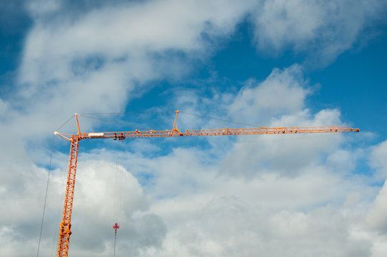 A Small Construction Crane On A Background Of Blue Sky. Equipment For The Construction Of Buildings.