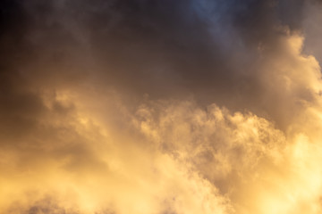 Golden dramatic sky. The heaven are filled with Sunny clouds at sunset. Natural cloud landscape.