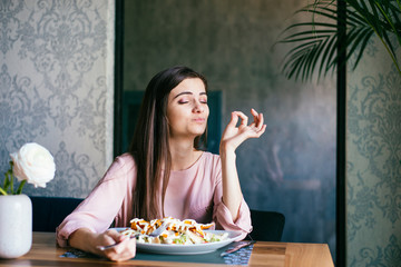 young lady sitting in a beautiful restaurant, enjoying lunch