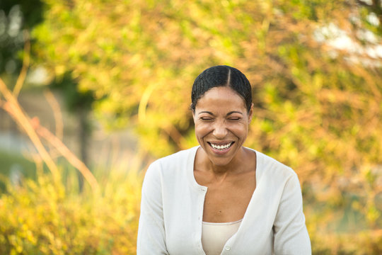 Mature confident African American woman smiling outside.
