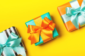 Line of attractive gifts on the yellow background. Present for St. Valentine's day, weddings, engagements, Mother's Day, birthday, New Year, Christmas, holidays. Flat lay
