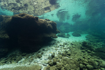 Rocks underwater on riverbed with clear freshwater. Underwater landscape. Traun river. Freshwater...
