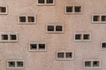 Obraz premium abstract background of ventilated windows in a relief plastered wall