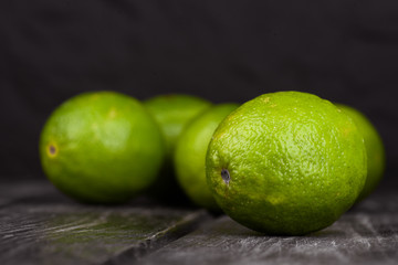 Fototapeta na wymiar lime juice with lime slices on wooden table. Detox diet