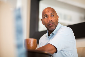Mature African American man working from his home office.