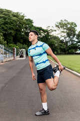 Young man doing sports and warm up exercises