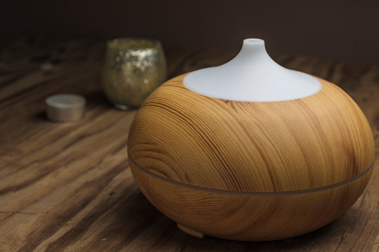 Wood finish aromatherapy diffuser used for dispensing natural oils into the air with health-beneficial results.