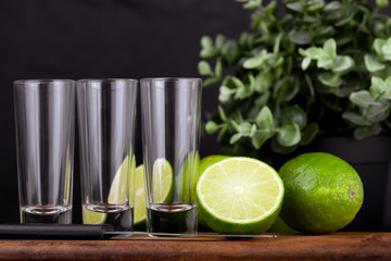 Mexican Gold Tequila with lime and salt on black background with copyspace.