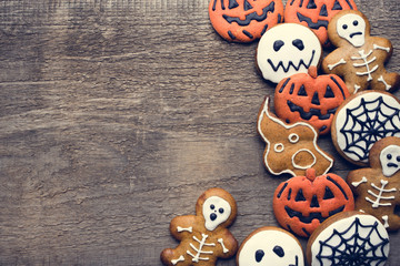 Halloween gingerbread cookies on wooden background. Flat lay. Copy space for your text.