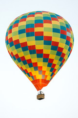 Many colorful hot air balloons flight above mountains - panorama of Cappadocia at sunrise. Wide landscape of Goreme valley in Cappadocia - billboard background for your travel concept in Turkey.