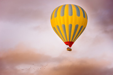 Many colorful hot air balloons flight above mountains - panorama of Cappadocia at sunrise. Wide landscape of Goreme valley in Cappadocia - billboard background for your travel concept in Turkey.