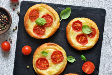 Mini pie with tomatoes and cheese. Quiche with vegetables and sauce top view.