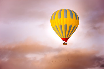 Fototapeta premium Many colorful hot air balloons flight above mountains - panorama of Cappadocia at sunrise. Wide landscape of Goreme valley in Cappadocia - billboard background for your travel concept in Turkey.
