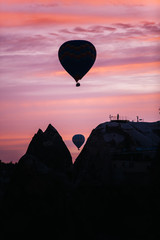 Fototapeta na wymiar Many colorful hot air balloons flight above mountains - panorama of Cappadocia at sunrise. Wide landscape of Goreme valley in Cappadocia - billboard background for your travel concept in Turkey.
