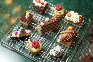 Dessert plate with assortment of sweets, piece of cake, cookies, biscuits