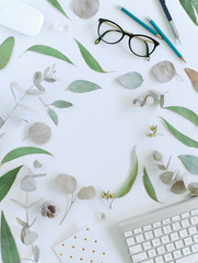 office space, eucalyptus leaf border blank space, green leaves, glasses, keyboard, flat lay border on white background, bright flatlay, composition, frame, creative concept, mockup, blank, copyspace