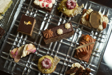 Dessert plate with assortment of sweets, piece of cake, cookies, biscuits