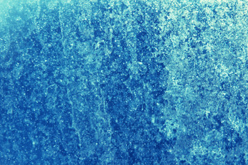 blue color in blur on a frozen winter window