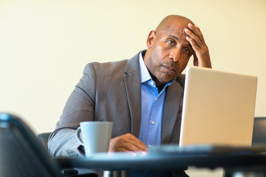 African American man having a difficult time at work.