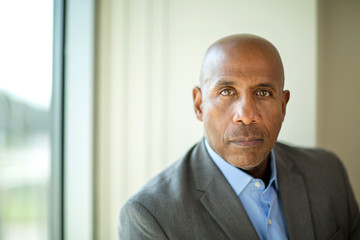 Happy mature African American man at work.