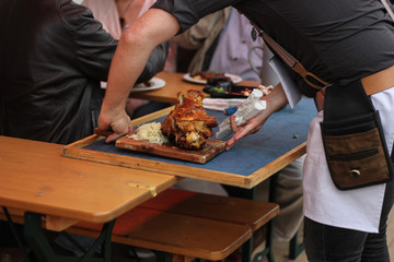 Bavarian food - crispy ham knock in beergarden at oktoberfest / munich beer festival
