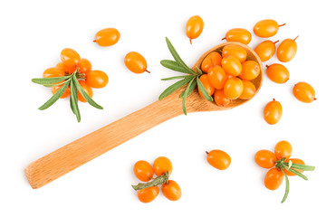 Sea buckthorn in wooden spoon. Fresh ripe berry with leaves isolated on white background. Top view. Flat lay pattern