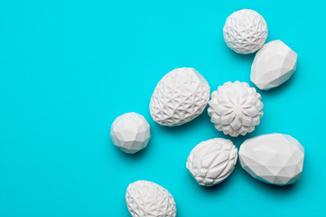 White geometric Easter eggs on blue background