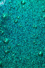 Macro of transparent glowing slime texture with glittering particles