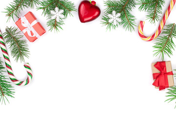 Christmas Frame of Fir tree branch with candy canes and snow isolated on white background with copy space for your text