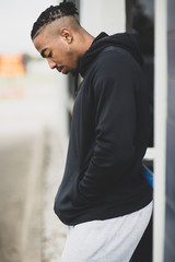 Young African American man outside wearing a hoddie.