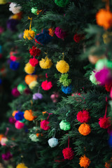 wool pompoms hanging on tree