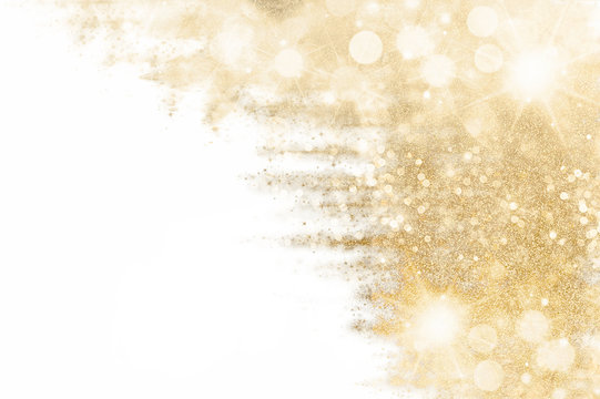 Festive shiny sparkles and twinkling bokeh. Golden glittering background.