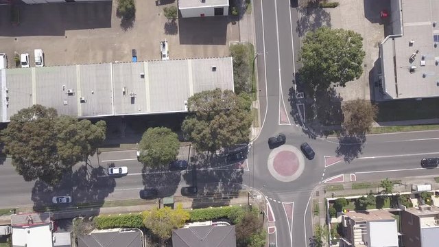 Aerial shot Multiple vehicles driving on roundabout and city road