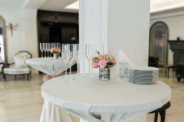 A small auxiliary table in the restaurant, on which there are empty glasses and plates