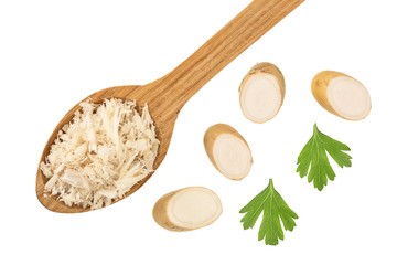 Horseradish root grated in spoon with slices isolated on white background