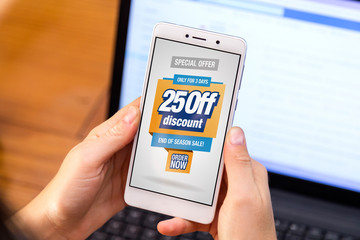 25% OFF Sale. Girl holding a smartphone with a 25% discount advertising on the screen. Marketing, ecommerce, cell phone publicity. Limited time. Buy Now.